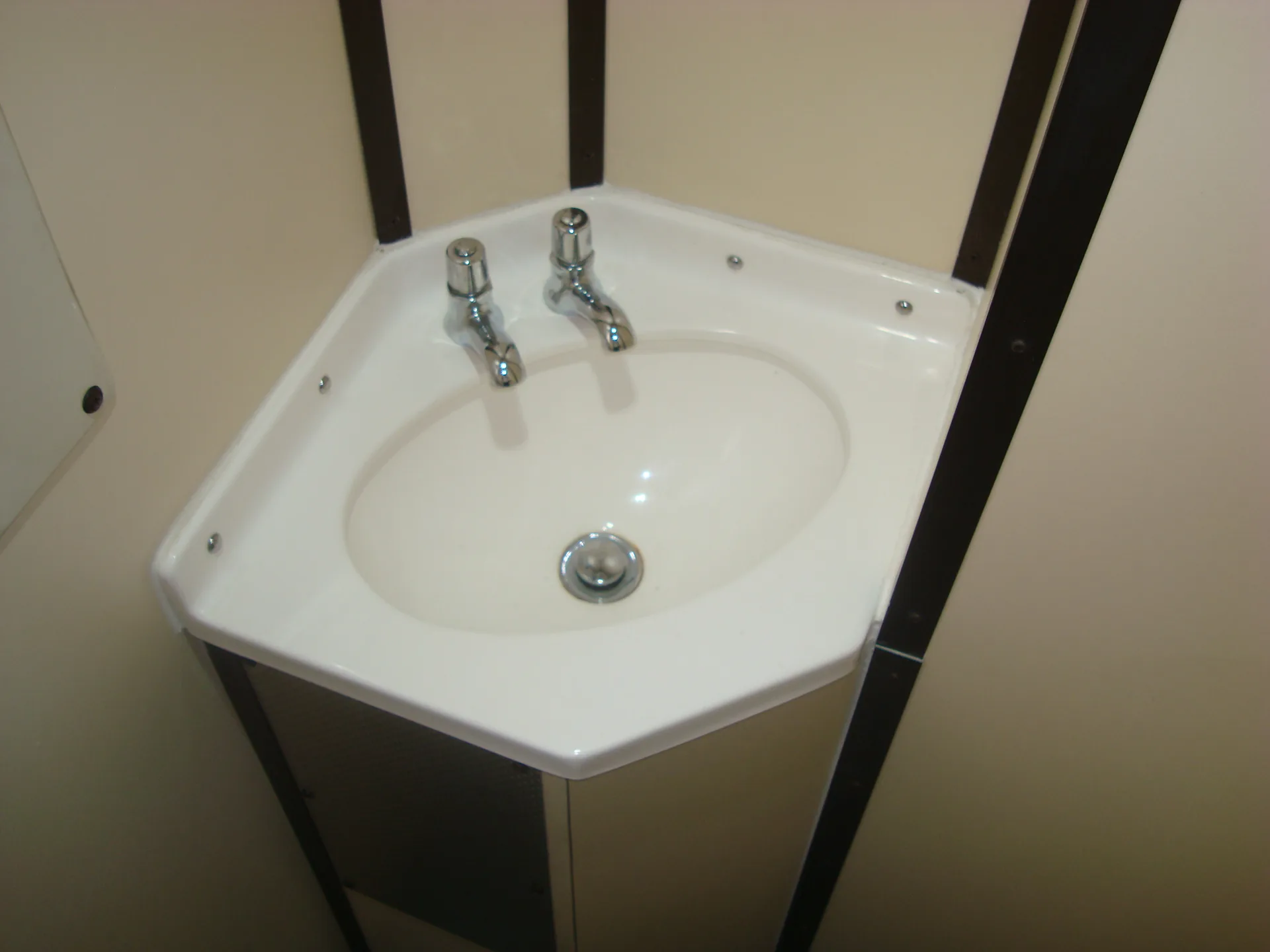 Chrome basin fittings in refurbished CFB Angola passenger coach bathroom
