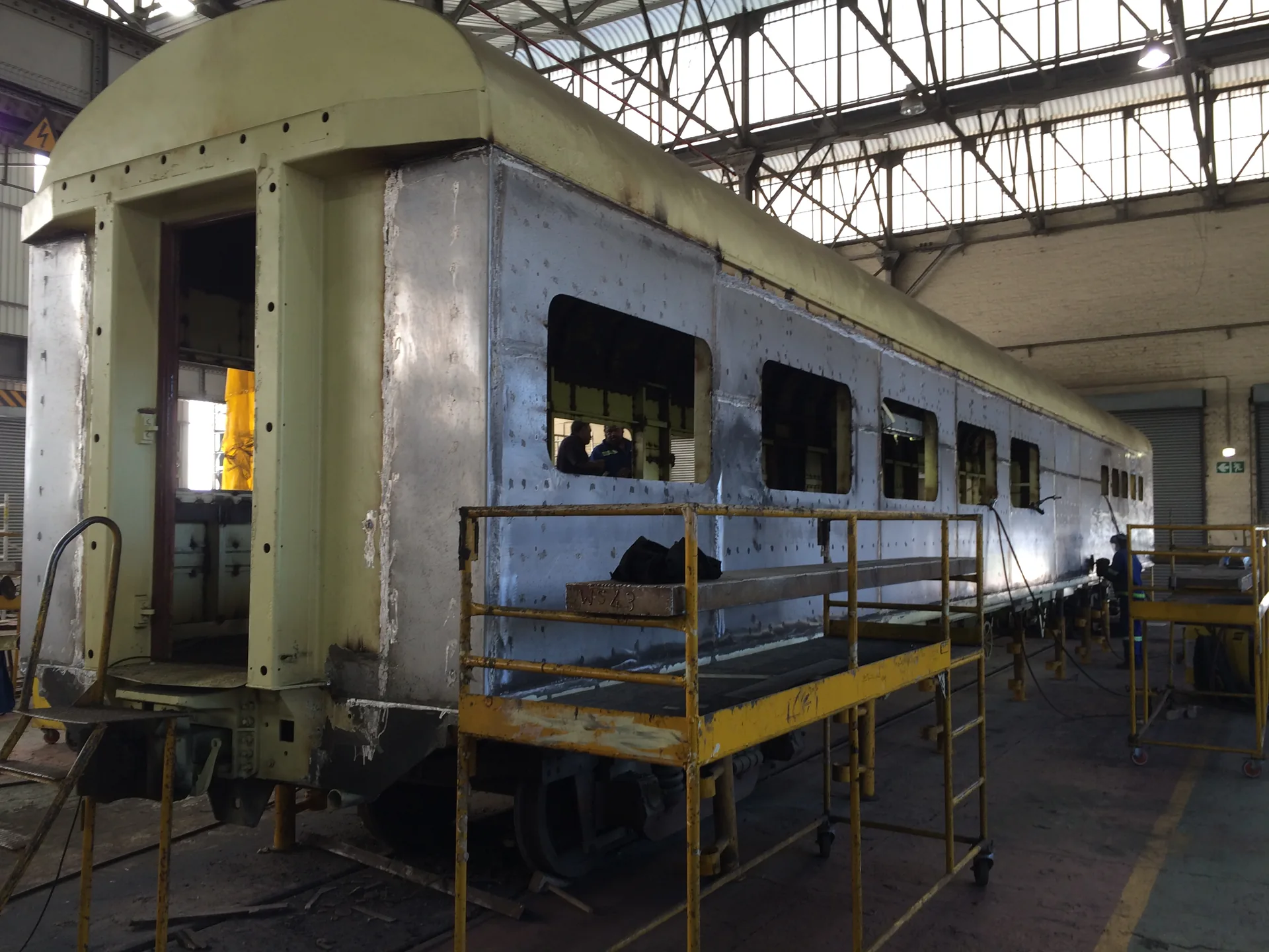 CFB Angola passenger coach stripped to shell on scaffolding — refurbishment phase