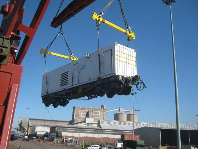 CFB Angola generator wagon suspended by crane during vessel loading Durban
