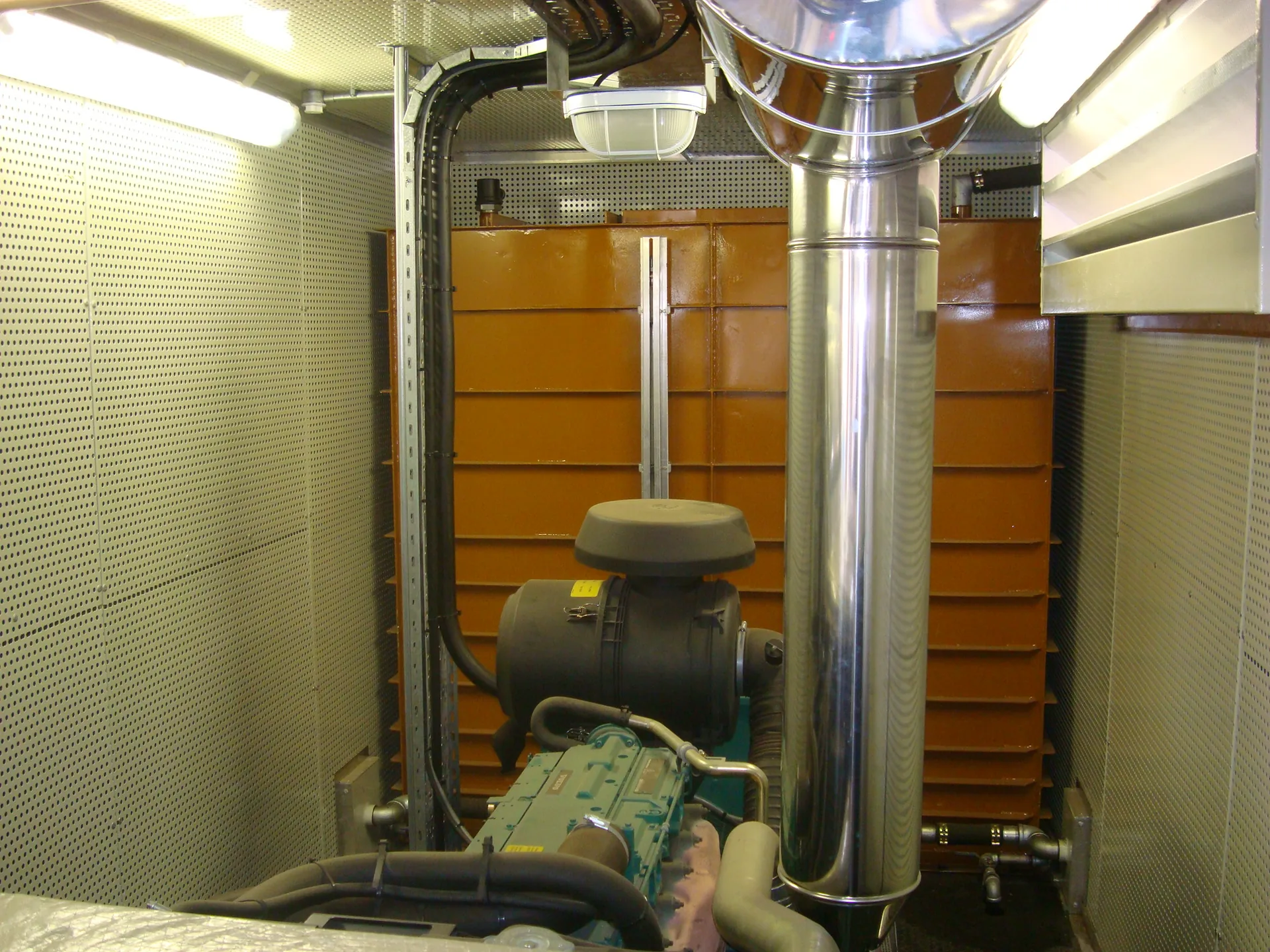 Generator exhaust stack installation — CFB Angola generator wagon interior