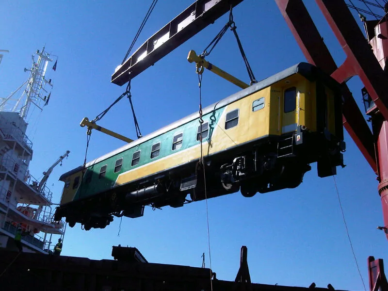 CFB Angola passenger coach fully suspended by crane — complete side view