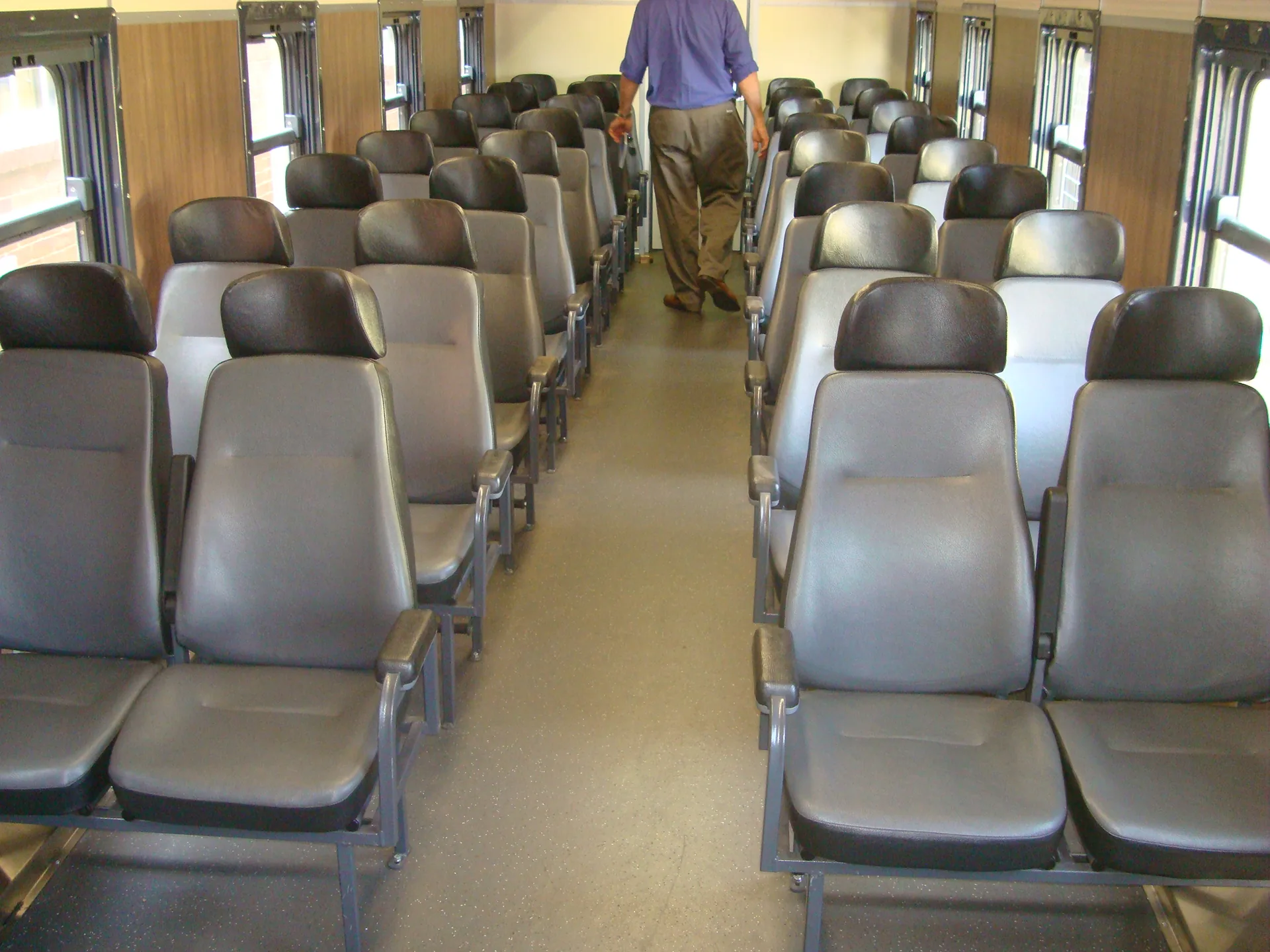Refurbished passenger coach interior — full seating view, CFB Angola project