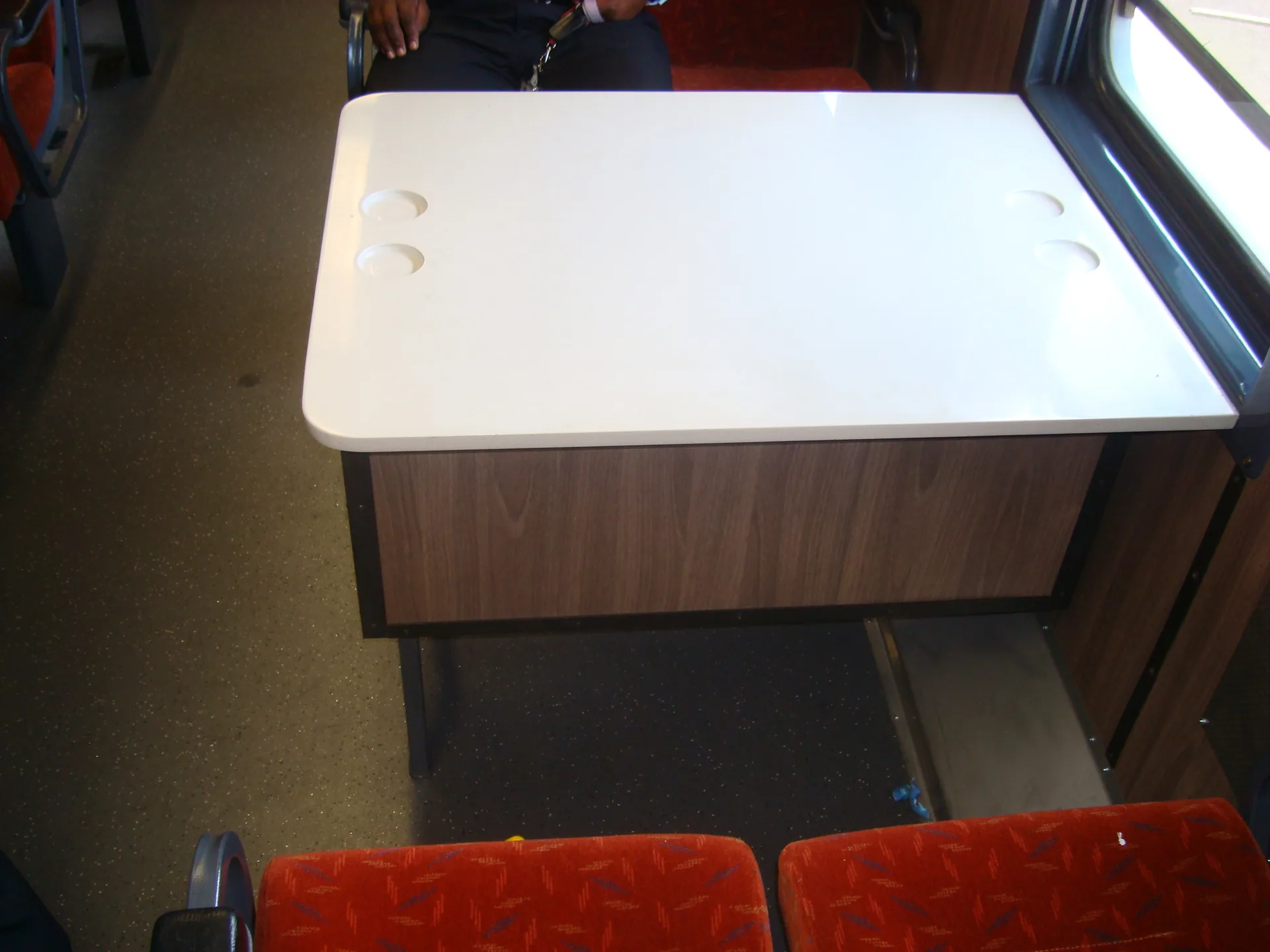 Refurbished dining car table with integrated cup holders — CFB Angola coach