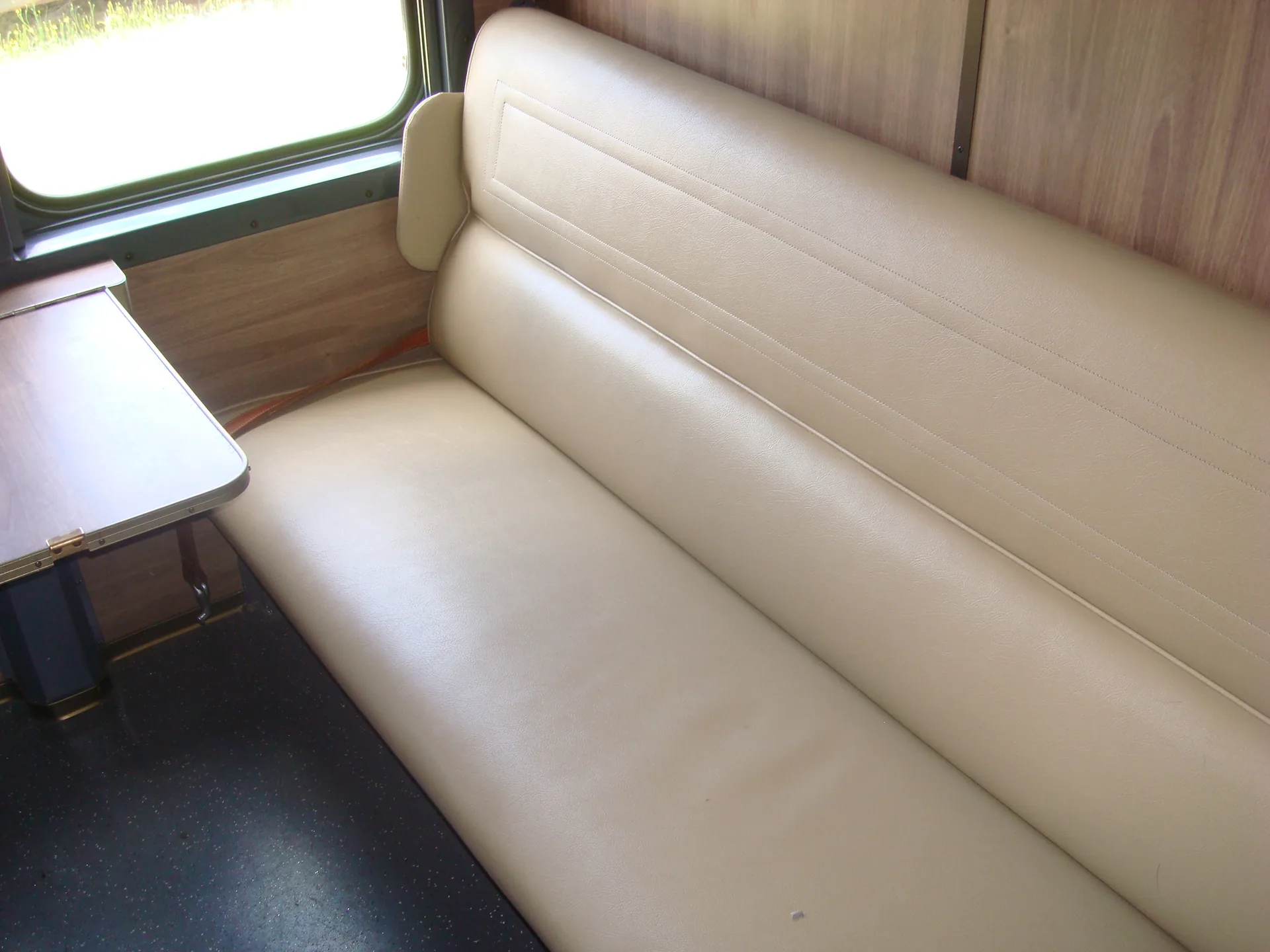Refurbished sleeper seat detail in cream — CFB Angola passenger coach interior