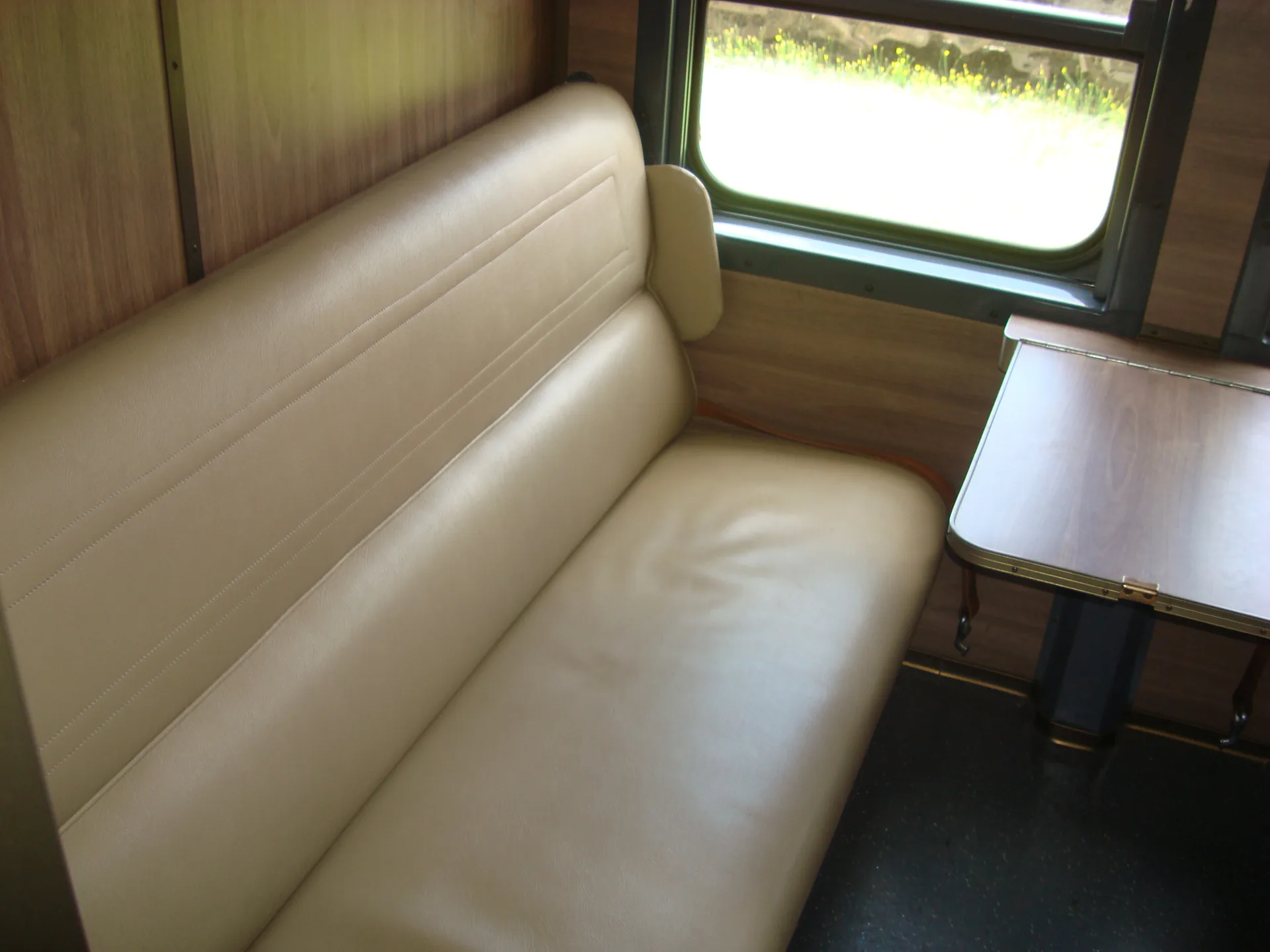 Refurbished sleeper seats in cream upholstery — CFB Angola passenger coach interior