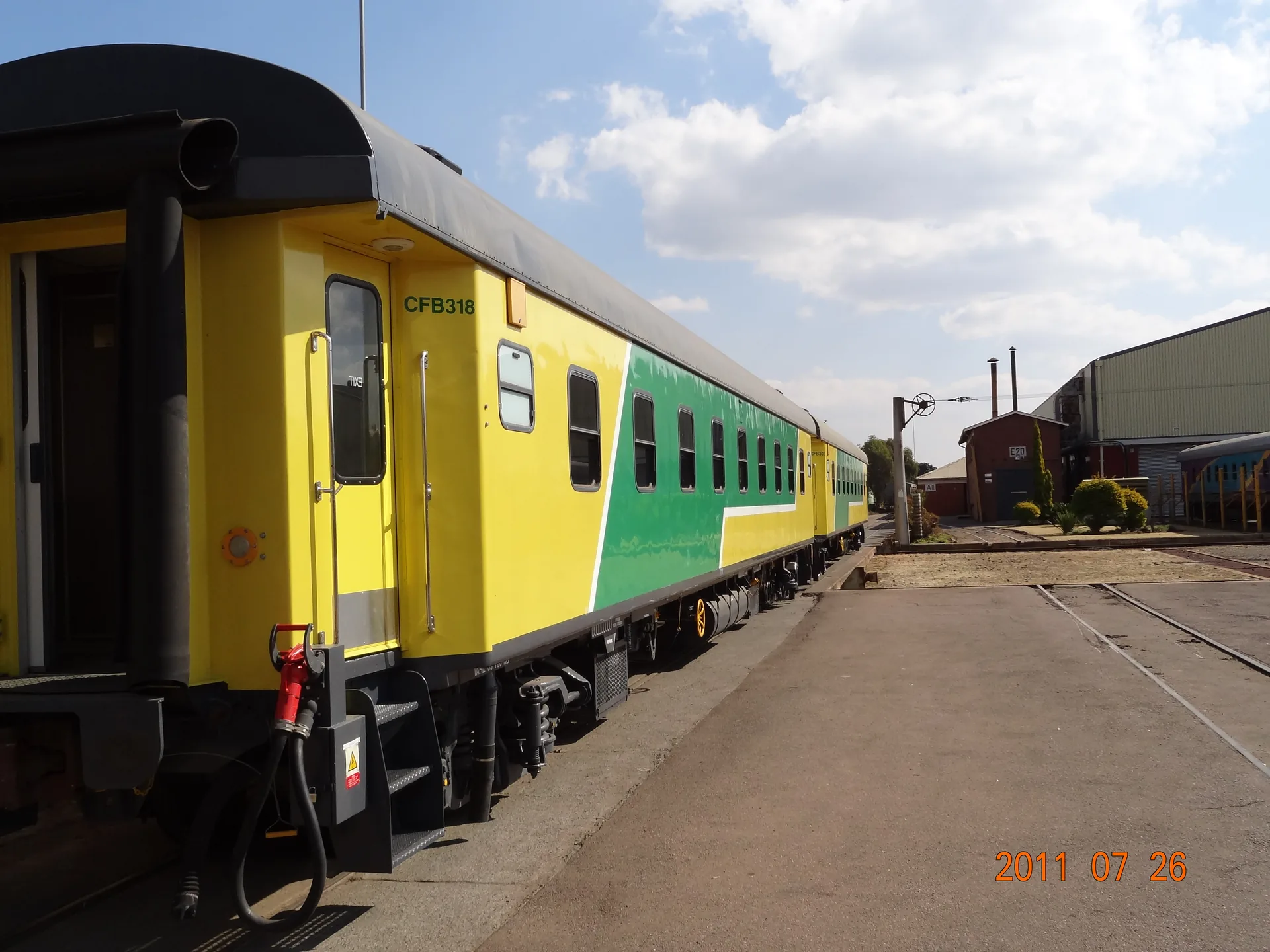 CFB318 refurbished passenger coach in final livery — Angola railway project
